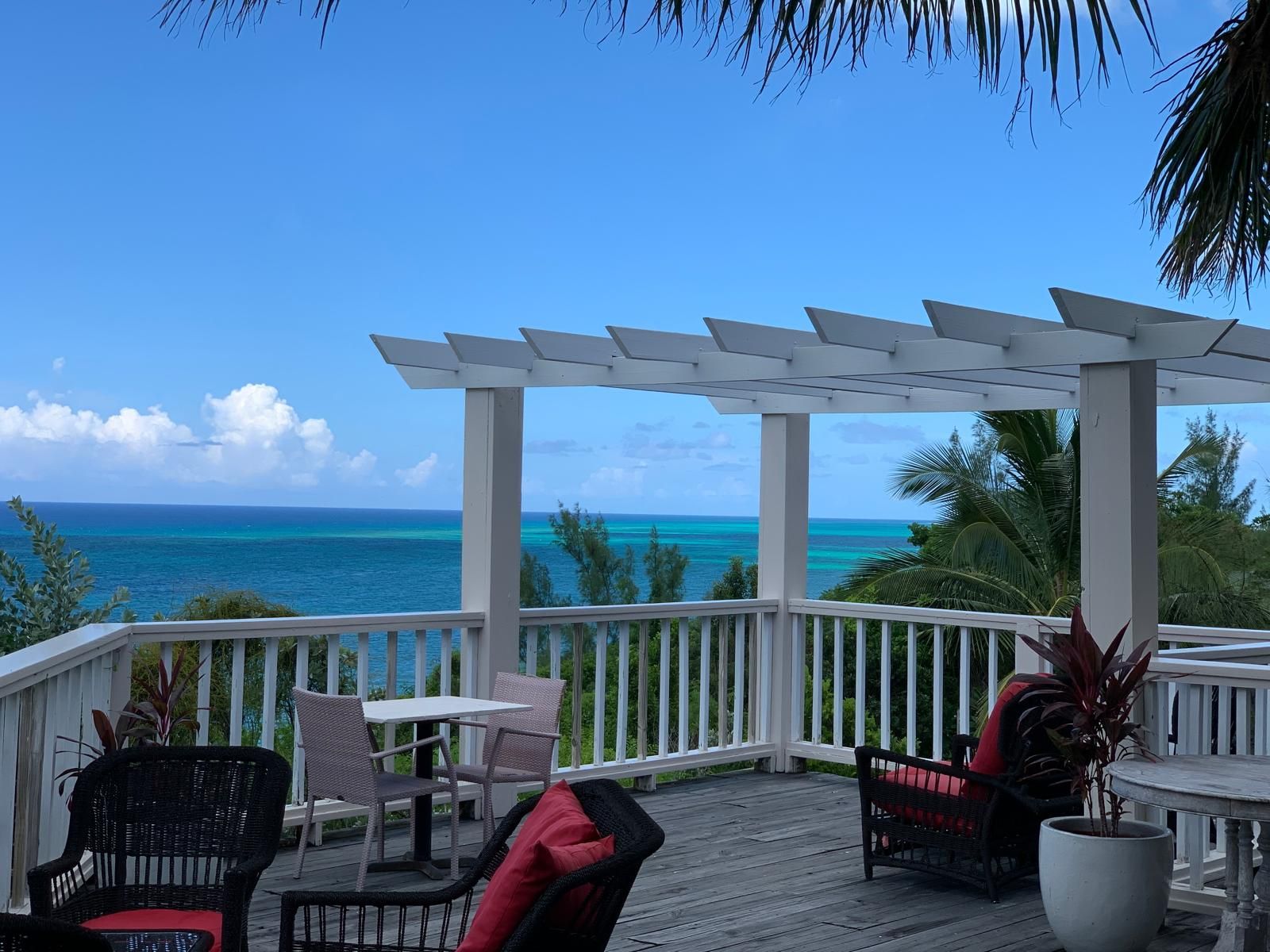 A tranquil garden terrace with sea views offers a peaceful welcome on arrival — A Stone's Throw Away. Arrive, settle in, and let island time take over.
