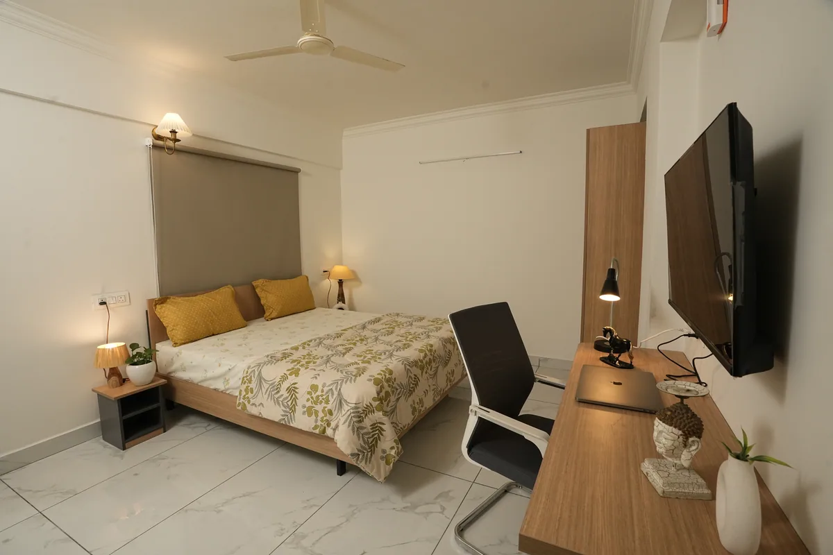 Bedroom with workspace at HomeSlice Sarjapur – Balcony Rooms