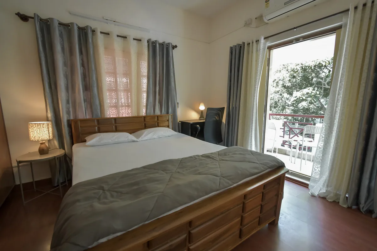 Deluxe Room with Balcony (AC) at Nazaara – Homestay in BTM Layout, photograph 1 of 16